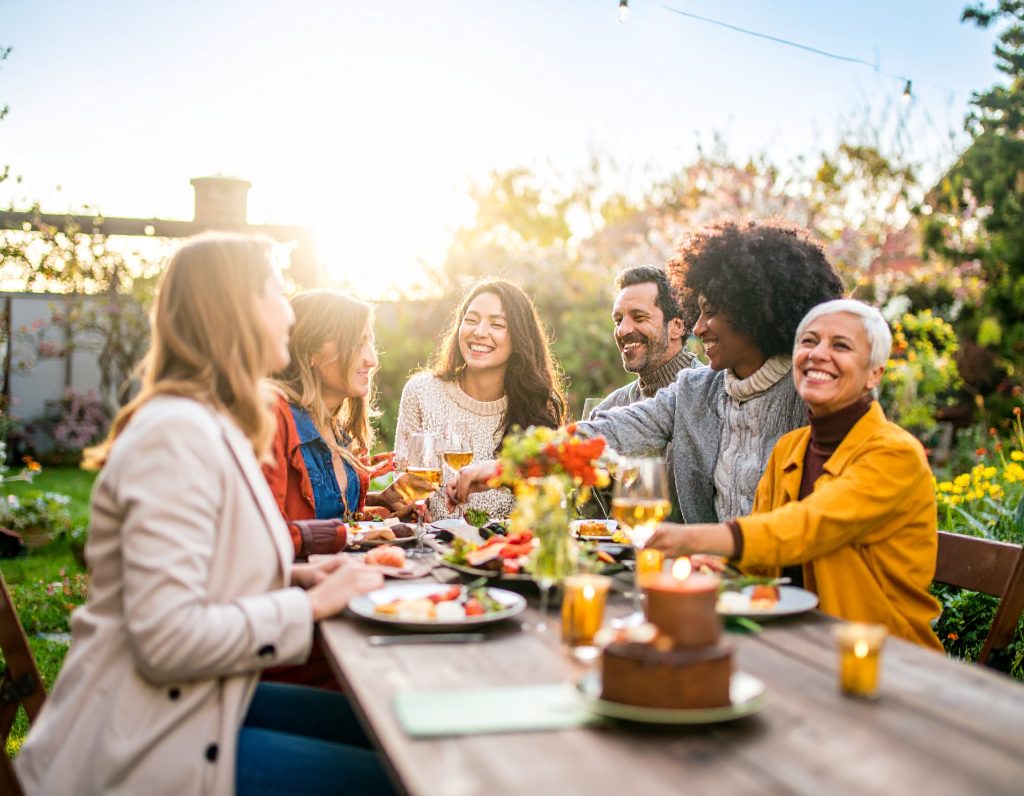 Effortless Outfit Inspiration for Every Season and Celebration 11 A smiling group of friends in different seasonal outfits enjoying brunch together.
