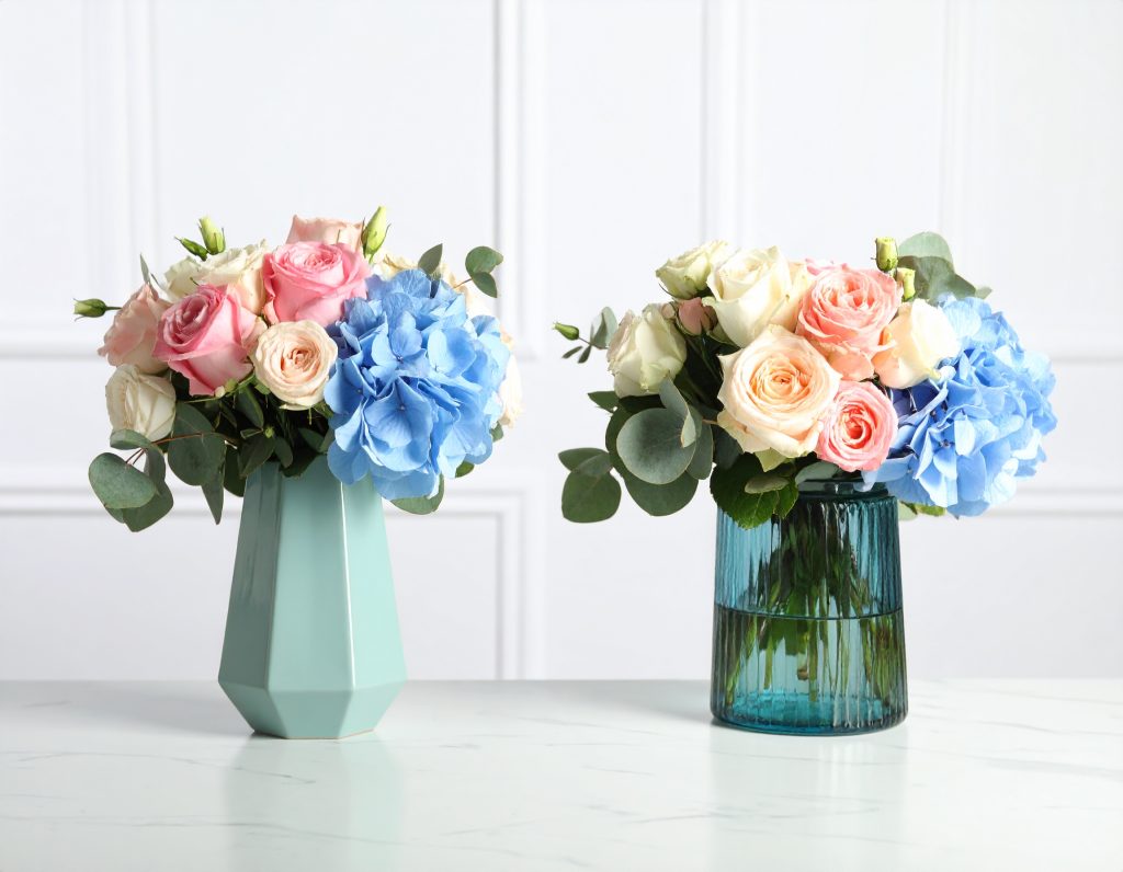 Secret Garden Wedding: Enchanting Pastel Floral Decor & Dreamy Wedding Chandeliers 10 Minimalist wedding corner with modern vases and single-stem pastel flowers on a white table.