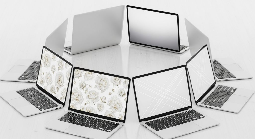 Circle of laptops displaying white wallpapers — floral, gradient, and abstract — symbolizing creativity and balance.