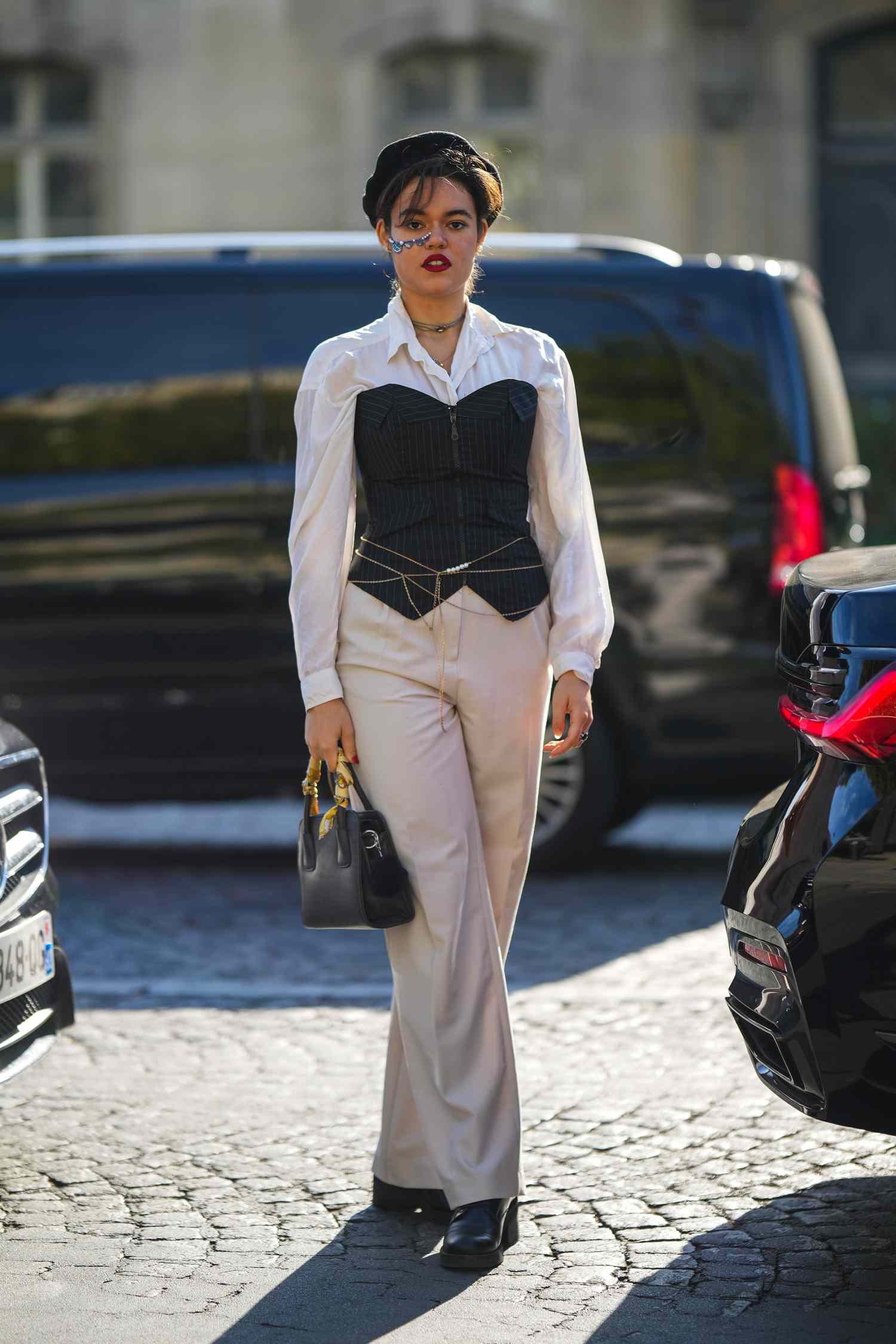 Woman styling a chic corset top with high-waisted jeans for a trendy everyday outfit look