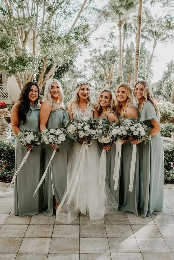 romantic sage green wedding reception decor with greenery flowers and candlelight