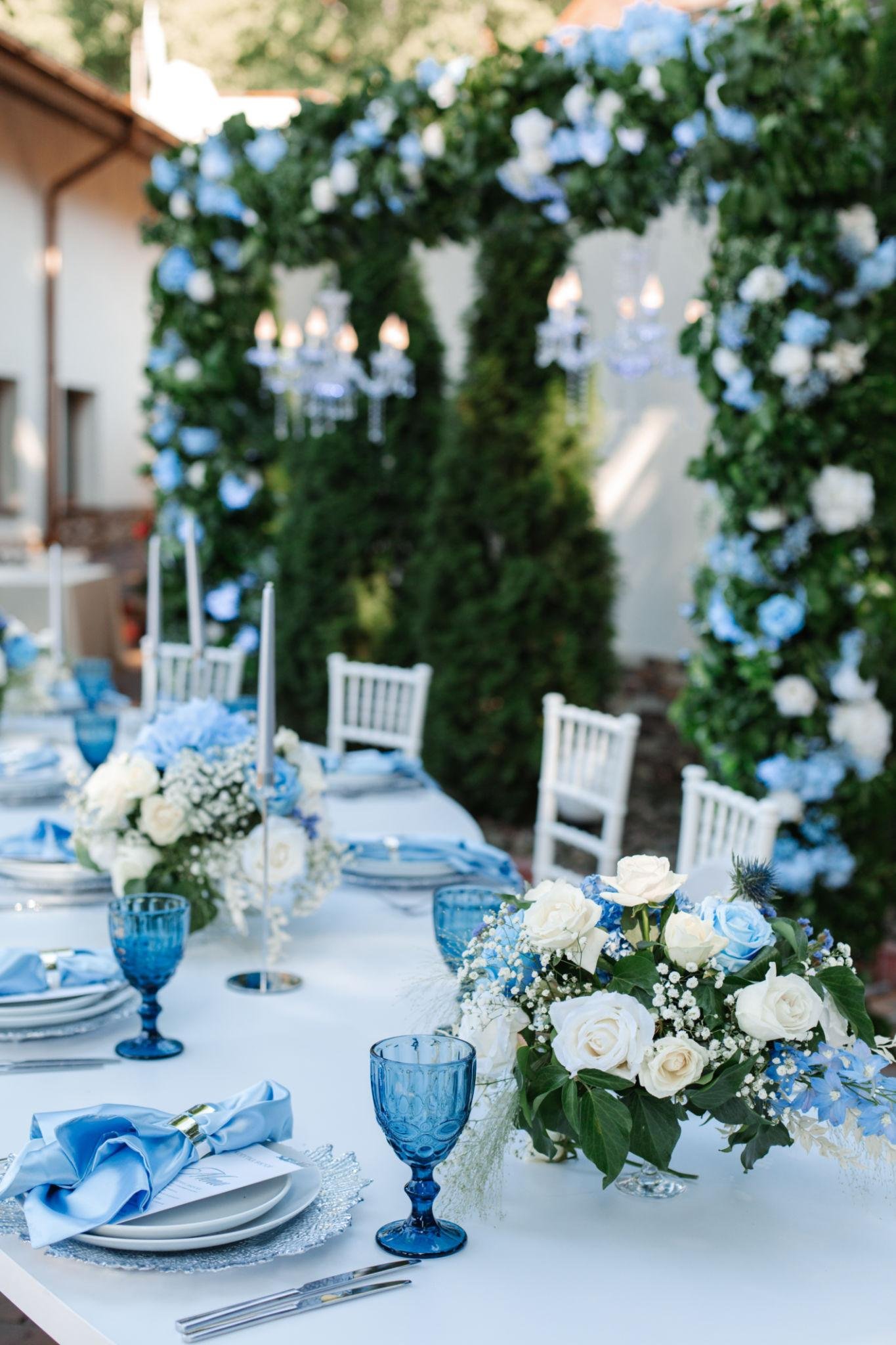 Elegant baby blue wedding theme reception decor with pastel flowers and candles