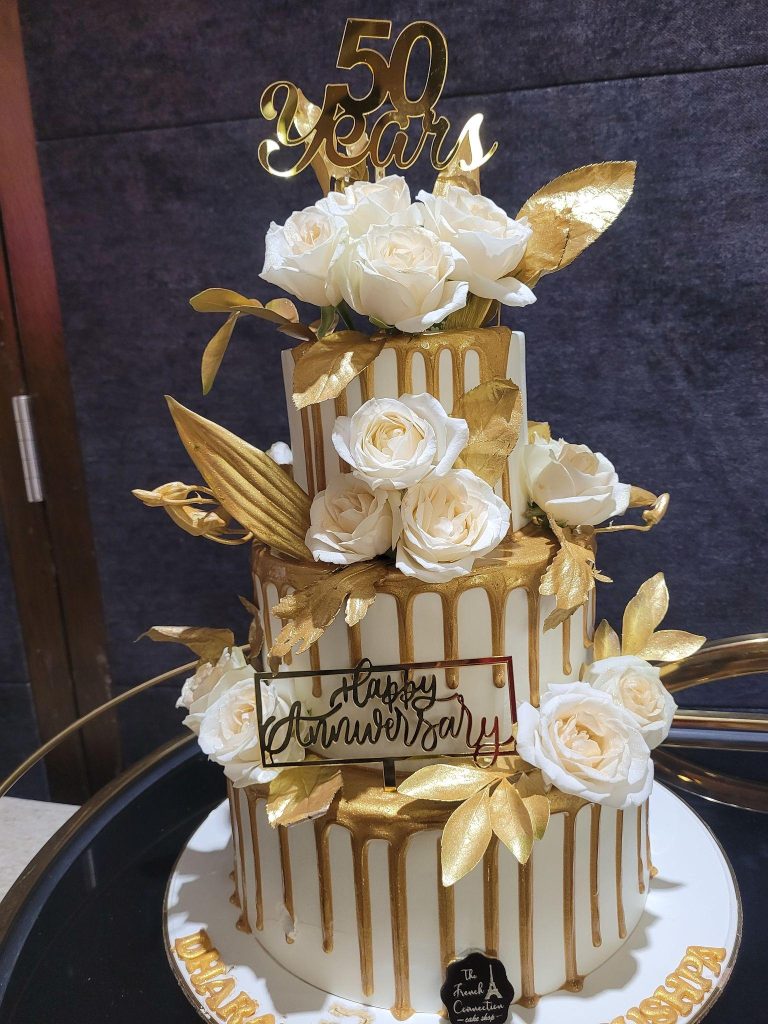 elegant 50th wedding anniversary celebration with gold decorations and cake