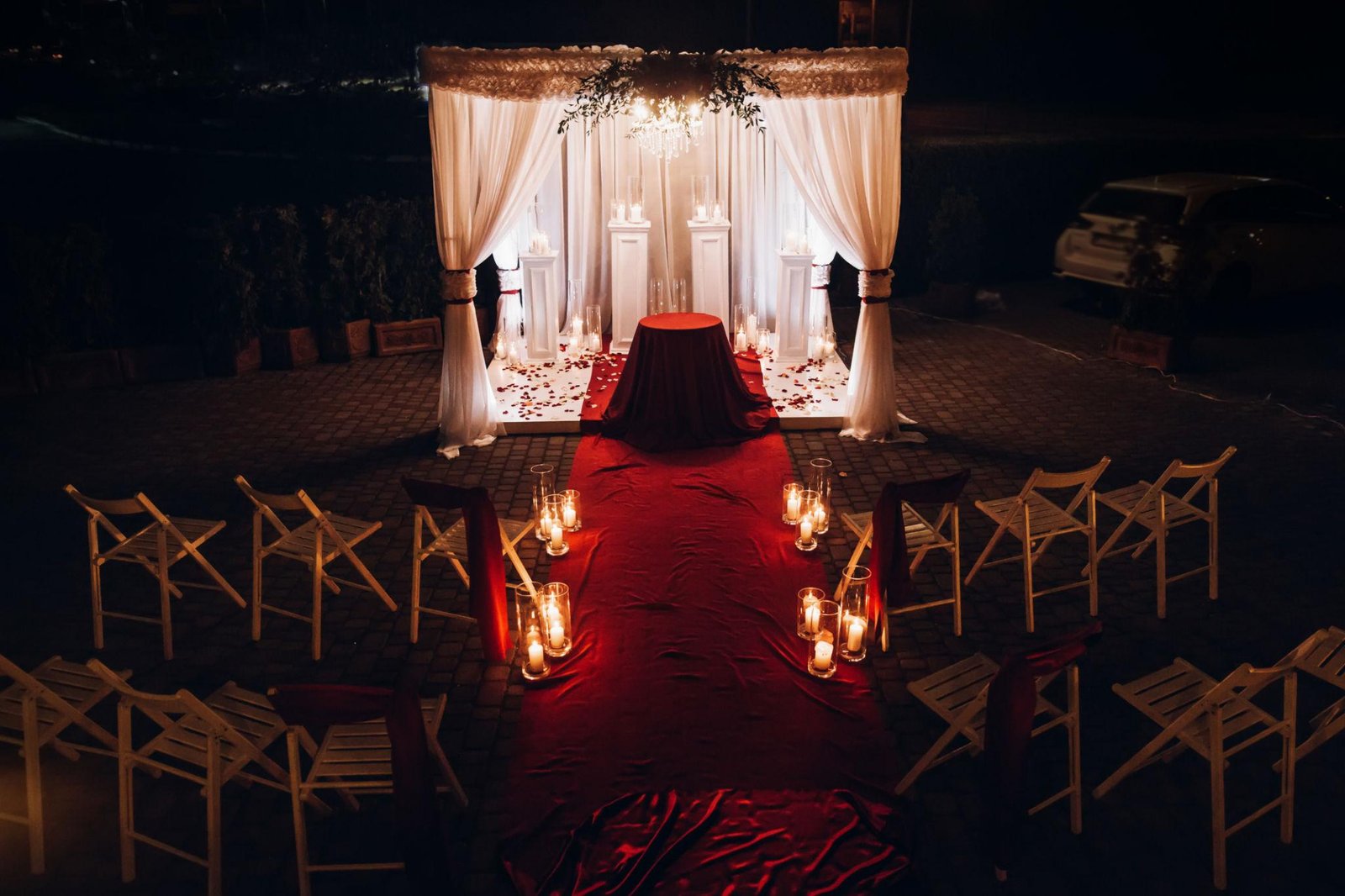 dark romantic wedding reception decor with candlelight burgundy flowers and elegant table styling