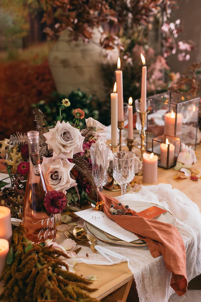 Elegant orange wedding 2026 reception decor with burnt orange flowers and candlelight