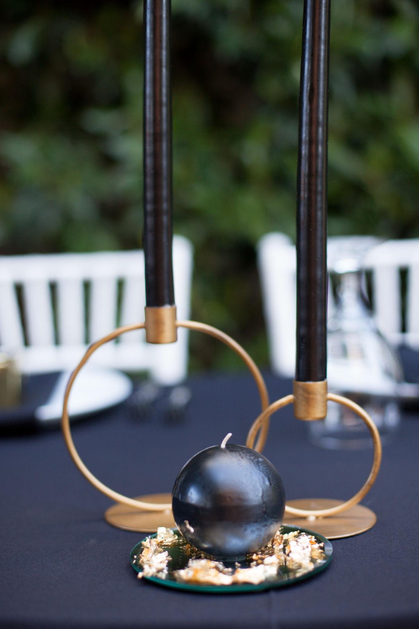 elegant black tie wedding reception with gold decor and candlelight in a luxury ballroom