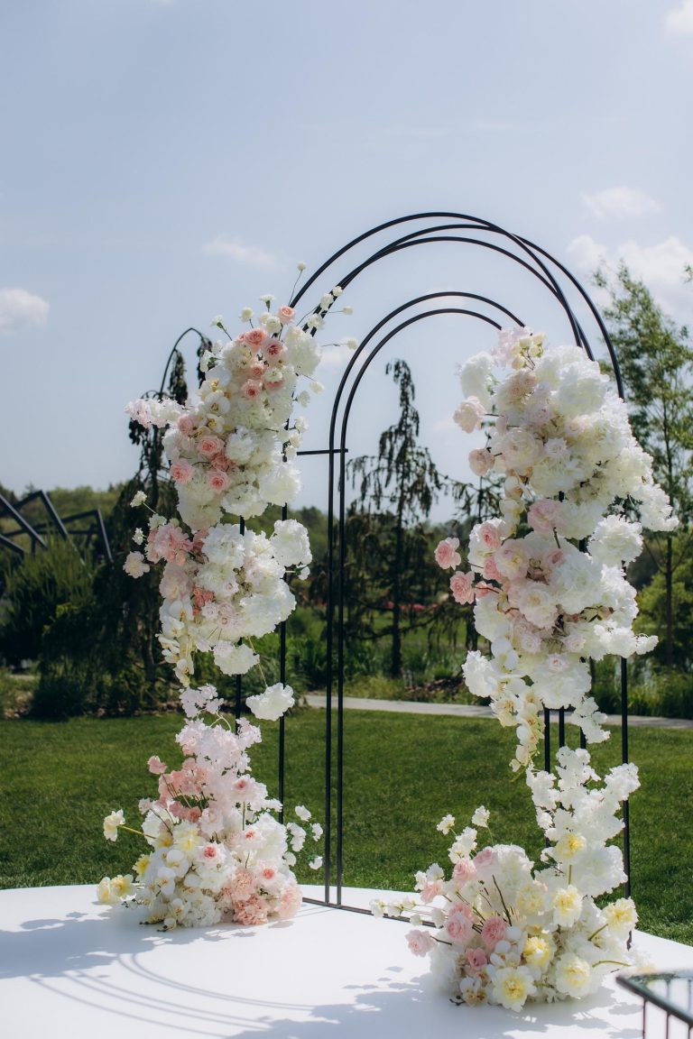 elegant neutral wedding reception decor with ivory flowers and champagne table styling