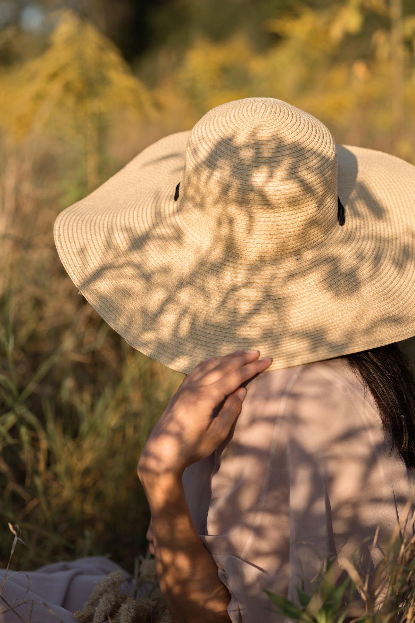ustainable fashion look with greenery and soft sunlight background