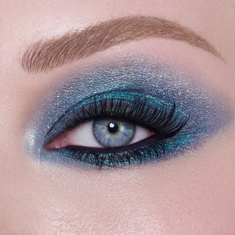 Close-up of blue eyes with glowing skin and soft glam makeup