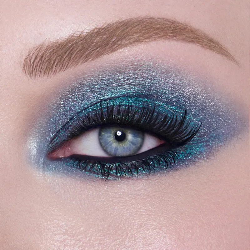 Close-up of blue eyes with glowing skin and soft glam makeup