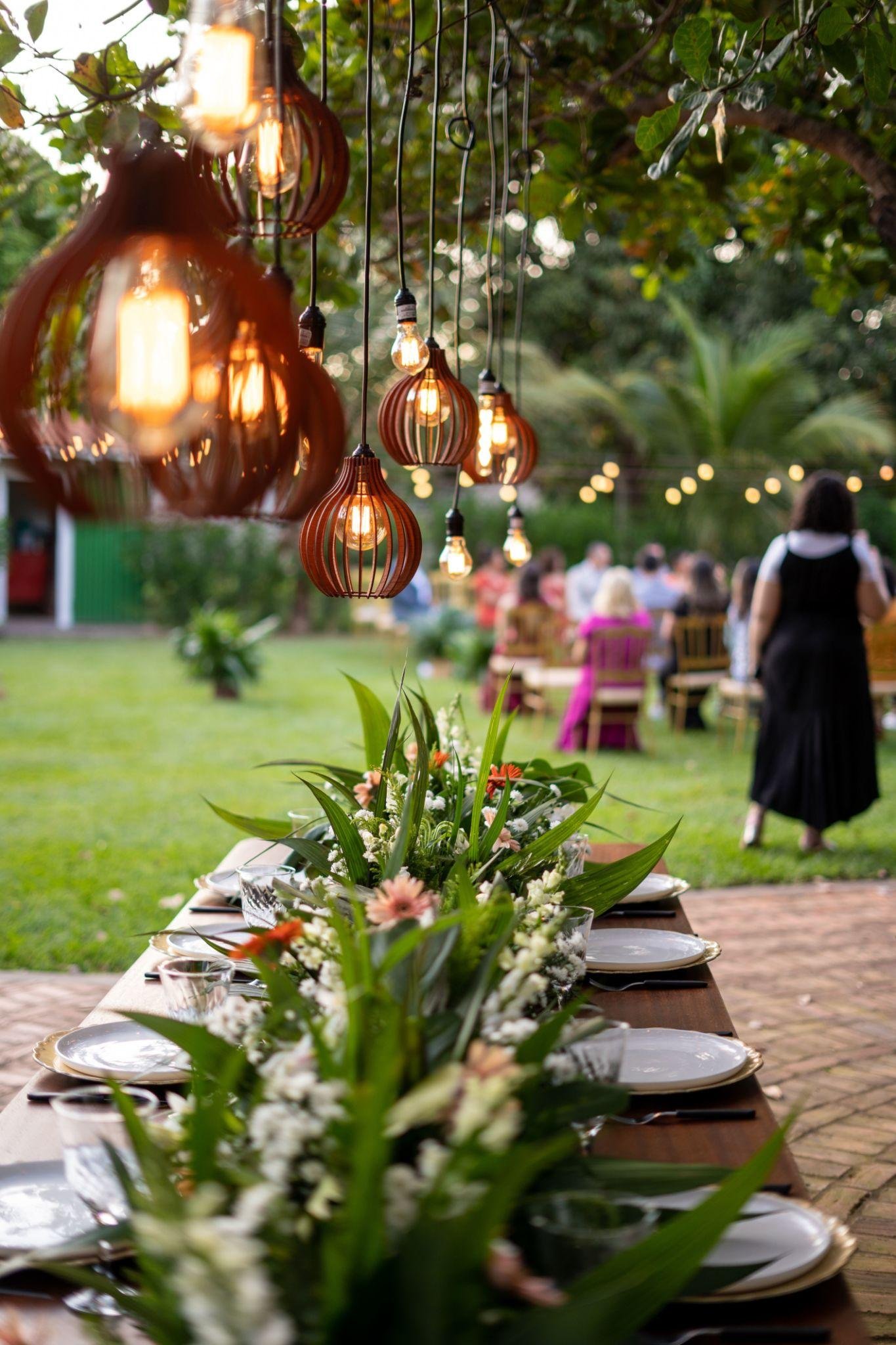 Elegant Garden Party setup with floral table decor, soft lighting, and outdoor seating creating a stylish and inviting atmosphere.