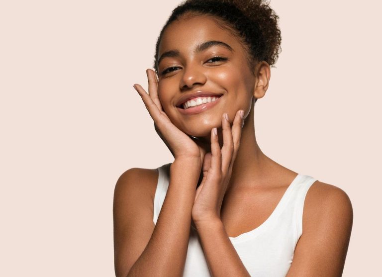 Natural beauty routine with glowing skin, minimal makeup, and skincare products arranged in a clean aesthetic setting, representing simple and effective beauty hacks for everyday glow.