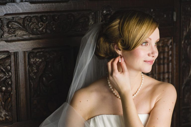Elegant bridal beauty feature image showing a stunning bride with romantic wedding hairstyle, soft makeup, delicate veil details, and luxurious bridal fashion styling in a timeless wedding aesthetic.