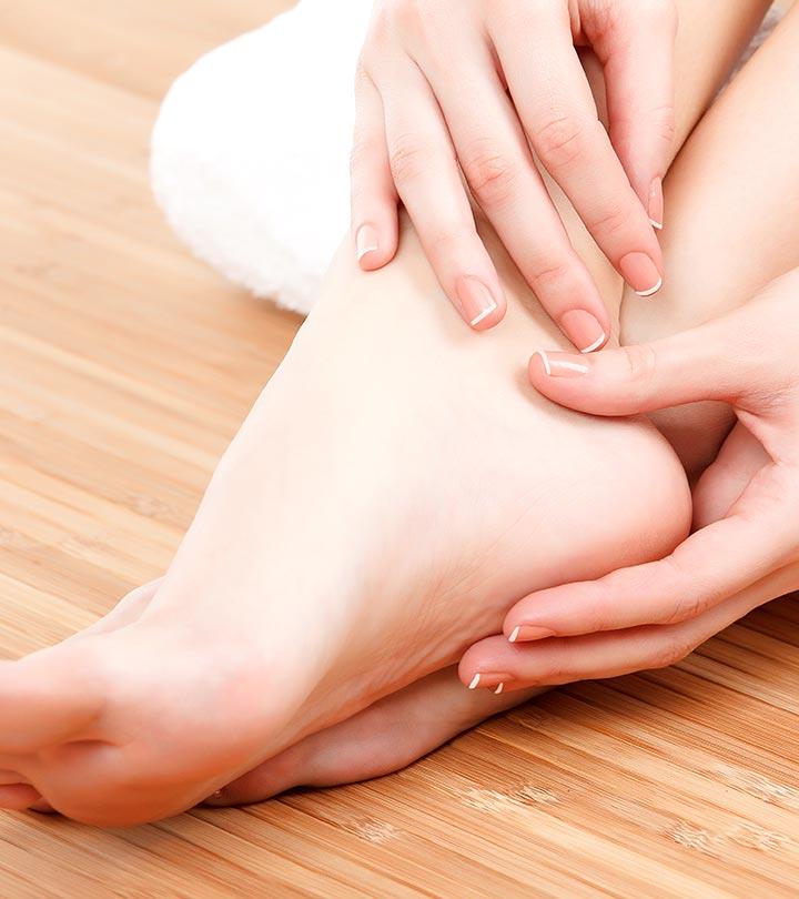 Soft and healthy feet receiving gentle massage care on a wooden floor, featuring clean natural nails and a relaxing self-care wellness atmosphere, perfect for a FOOT CARE