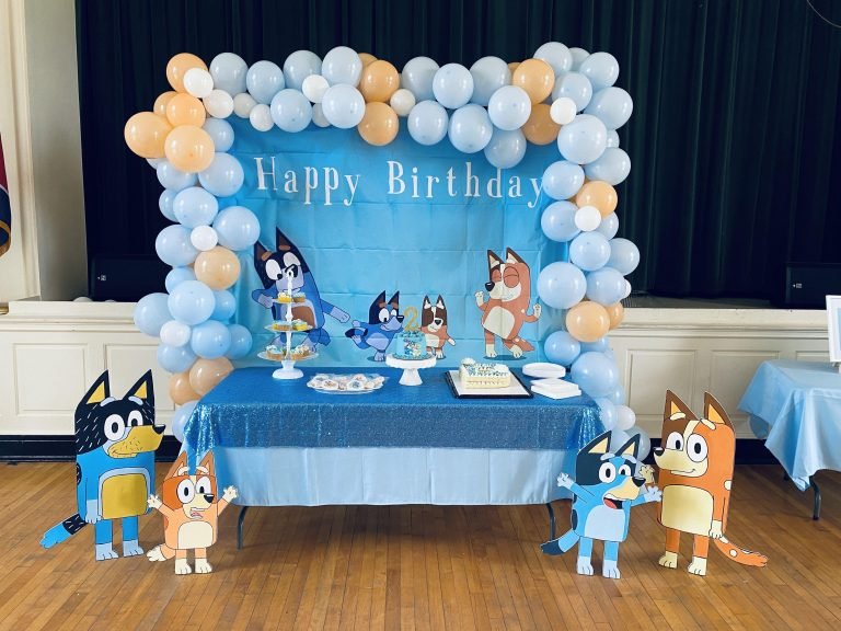 Bluey Birthday Party Ideas featuring a colorful balloon garland, themed birthday cake, dessert table, character decorations, and a fun kids' party setup.